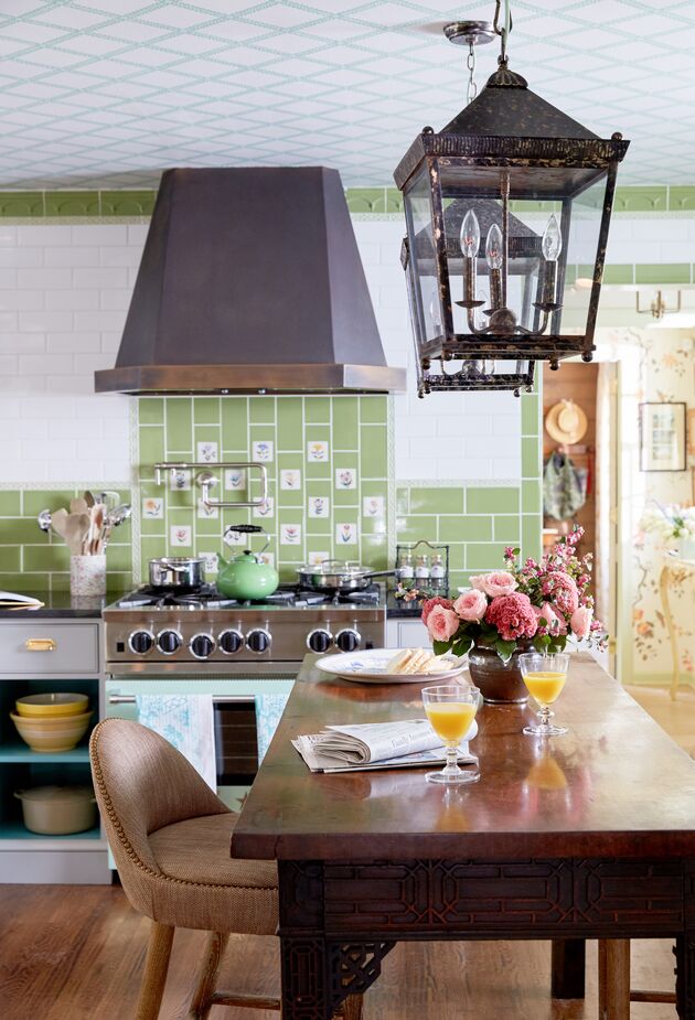 Sprightly green and floral tiles add joie de vivre to this kitchen’s white subway tiles, and because they’re used as an accent, they don’t overwhelm the space. Design by Madcap Cottage. Photo by Tony Vu.
